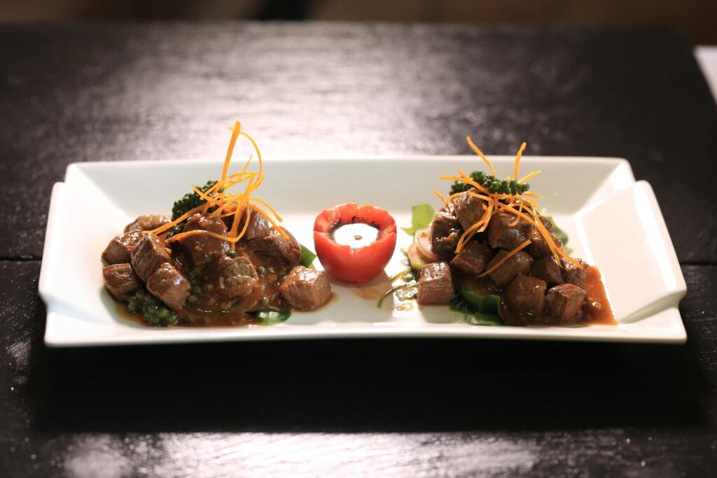pexels-photo-2532443-2532443 A beautifully presented beef dish in Phnom Penh, Cambodia, garnished with vegetables.