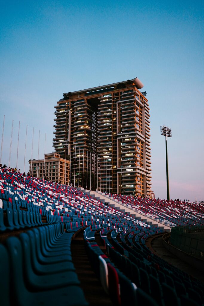 pexels-photo-31007654-31007654 A stunning view of a stadium with urban architecture at twilight in Phnom Penh, Cambodia.